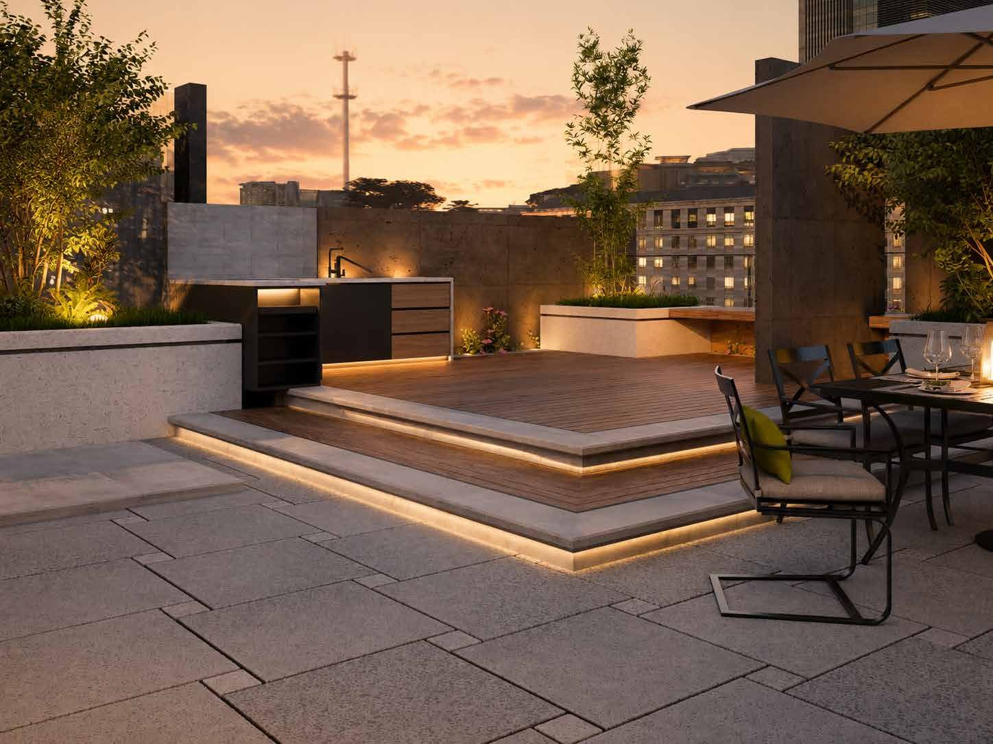 Landscaped rooftop grilling and outdoor dining area at Hawa during sunset